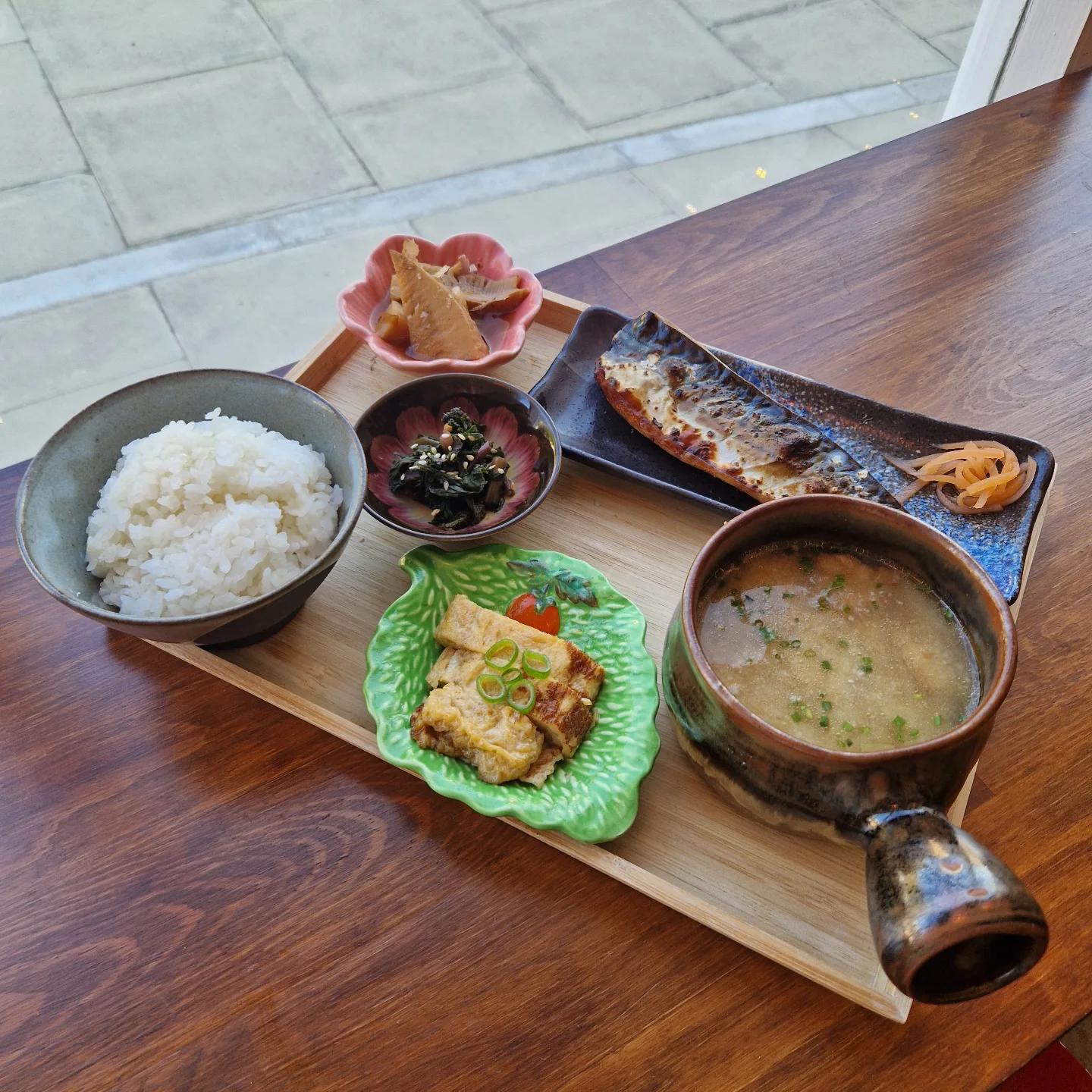 Japanese set meal with fish, rice, soup and small sides
